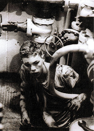 G.E. Clark climbs out of the bilge after pulling the drain plug 13 March 1965