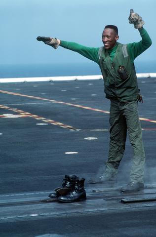 Aviation Boatswain`s Mate 3rd Class Ronnie Josey jokingly gives the "ready for launch" signal after placing the catapu
