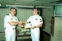 Lt. Godinez reenlisting AW2 Dickover.