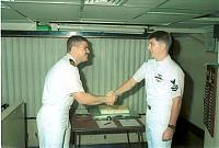 Lt. Godinez reenlisting AW2 Dickover.