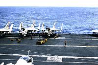 Flight deck scene, loading bombs on A7's