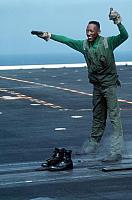 Aviation Boatswain`s Mate 3rd Class Ronnie Josey jokingly gives the "ready for launch" signal after placing the catapu