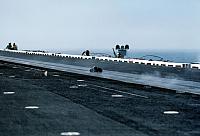 Deckedge crewmen cheer as the catapult officer`s boots travel down the No. 1 catapult aboard the aircraft carrier USS MIDWAY (CV