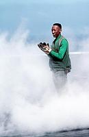 Aviation Boatswain`s Mate 3rd Class Ronnie Josey applauds, after watching the launch of the catapult officer`s boots. - 24 SEP 1