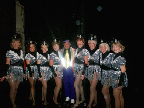 Lenny Viccaro with the chorus line beauties in his review. This is just one Aviation Boatswain's Mate success story.