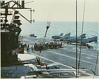 Flight deck crew in the process of rigging the barricade