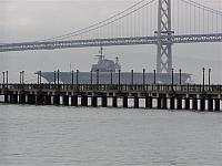 Midway making her way under the Oakland-San Francisco Bay Bridge on New Year' Eve 2003 on her way to San Diego - Courtesy of Ric